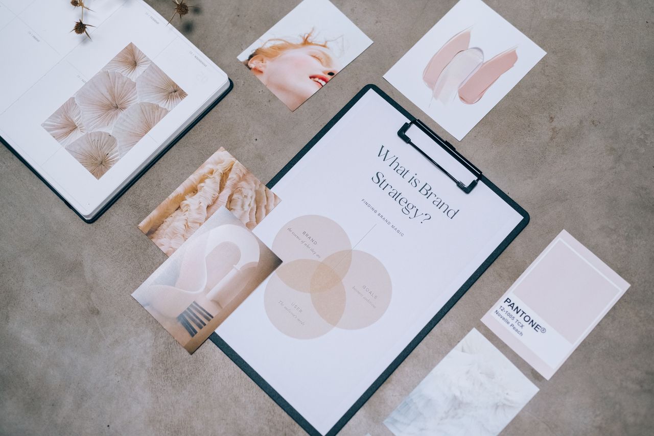 services-img Flat lay showing branding materials and design concepts for creative strategy discussions.
